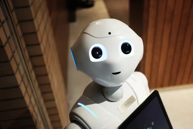 A humanoid service robot holding a tablet